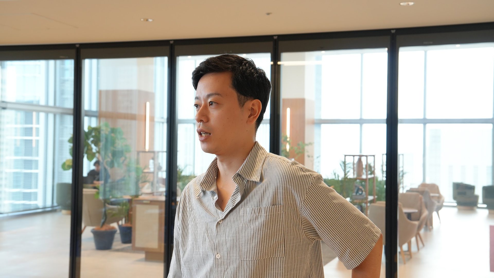 Takeshi Okada talking during the interview on an upper floor of a Recruit office